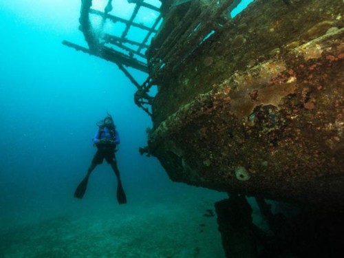 Nitrox Diver in a swim through cave.