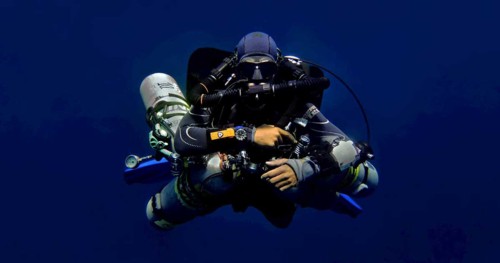 Scuba diver with way to much gear.