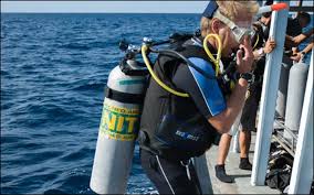 Padi nitrox course graduate prepares to dive.