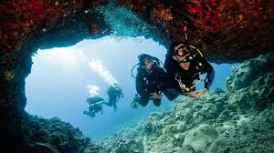 Nitrox Diver in a swim through cave.