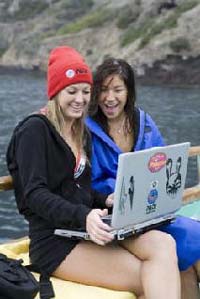 Girls taking the online nitrox certification course while on a dive boat..